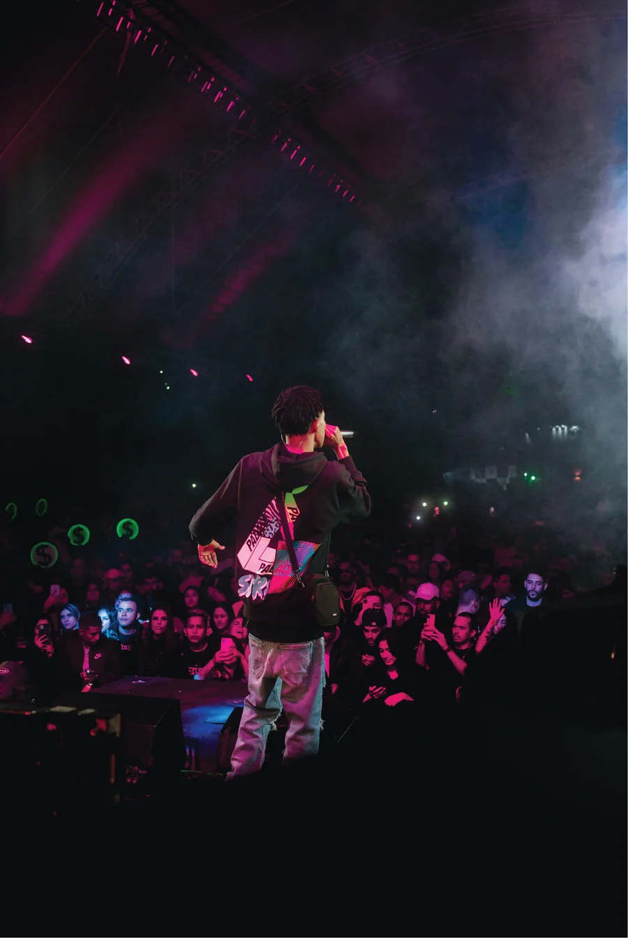 Performer on stage before a crowd